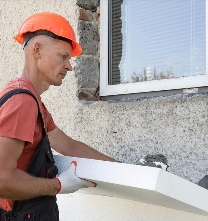 Worker applying insulation panel